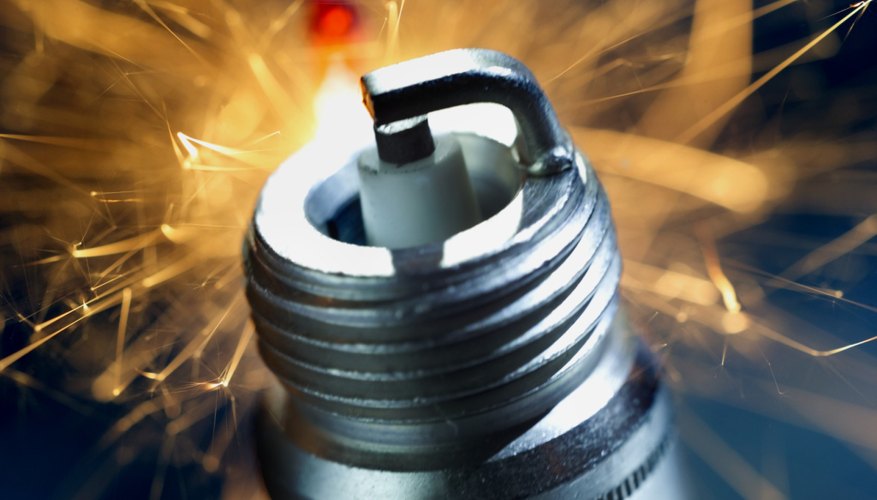 Close-up of a spark plug with sparks exploding