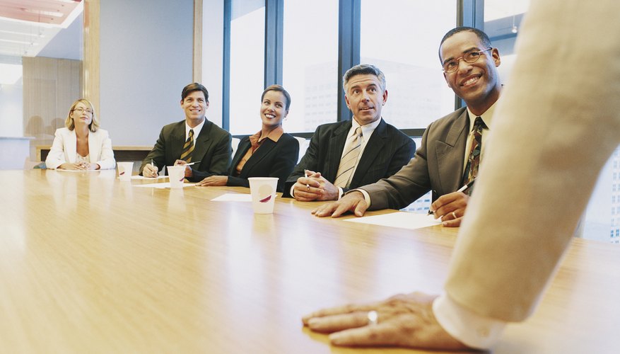 Business People in a Meeting Listening to Their CEO