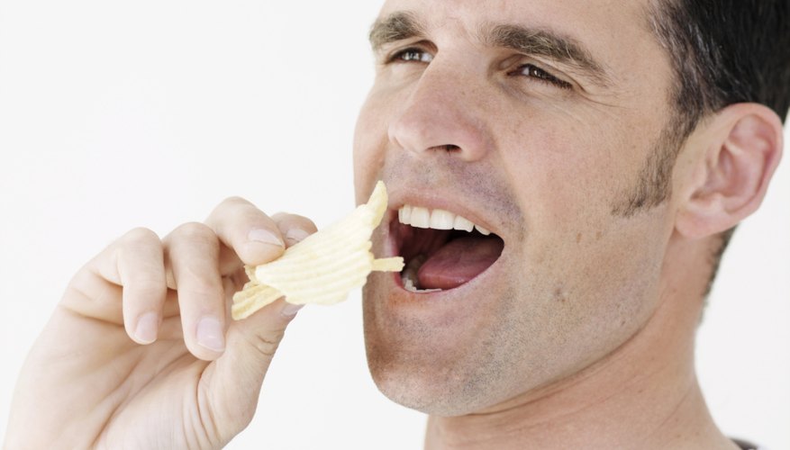 Man eating potato chips Man eating potato chips