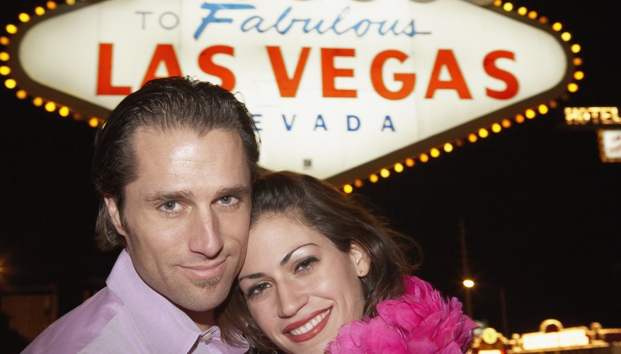 Couple hugging in front of neon sign
