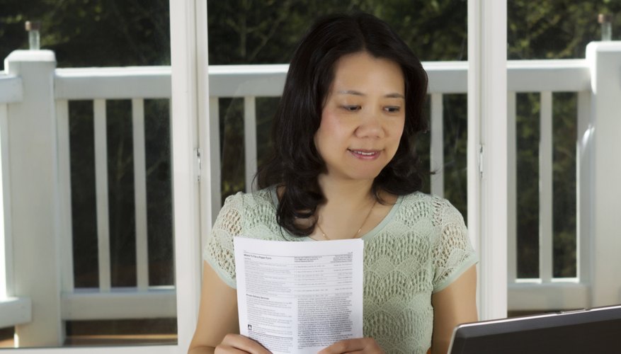A tax preparer reviewing income tax forms