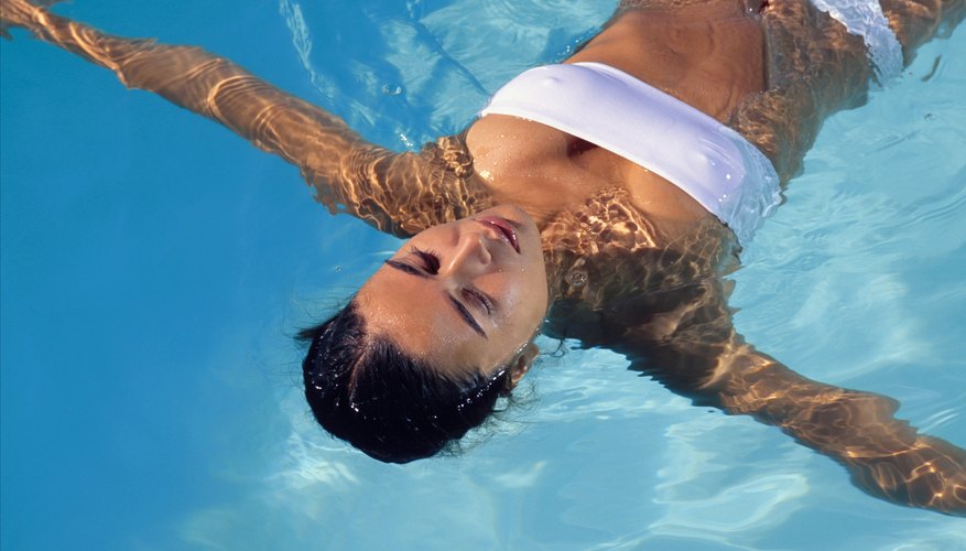 Photo Credit: Goodshoot/Goodshoot/Getty Images By spreading your arms you displace more water and float more easily.
