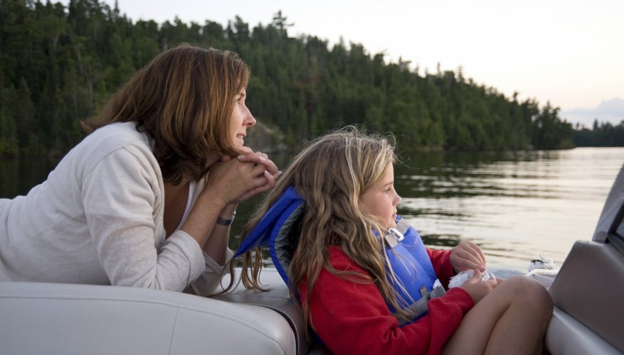 Photo Credit: Design Pics/Design Pics/Getty Images A mother and daughter enjoy a boat ride through the Canadian wilderness.