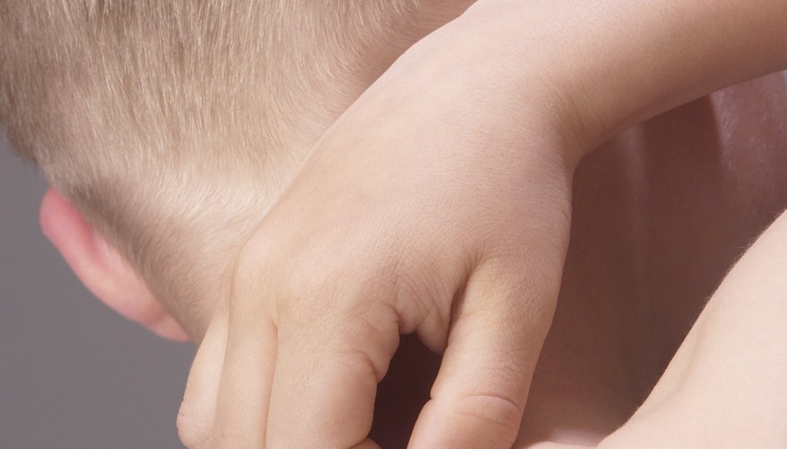 Little kid scratching his skin Little kid scratching his skin