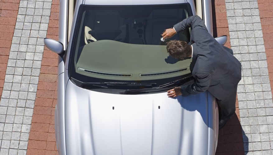 High angle view of man cleaning car windshield