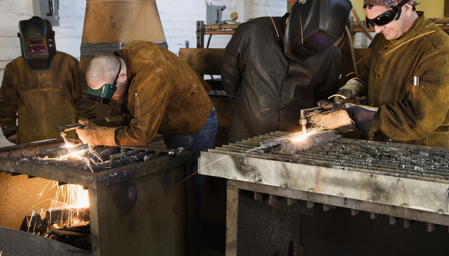 Welders working with torches in foundry