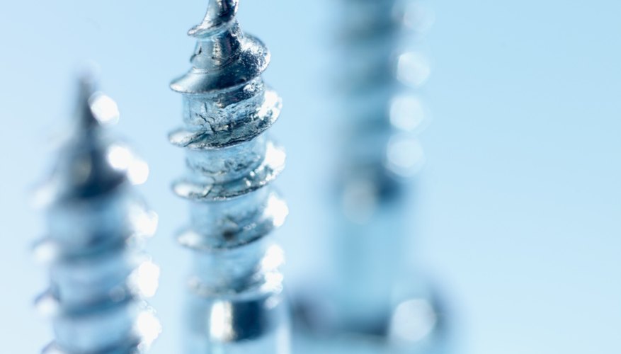 Close-up of metal bolt with two blurred bolts in the background