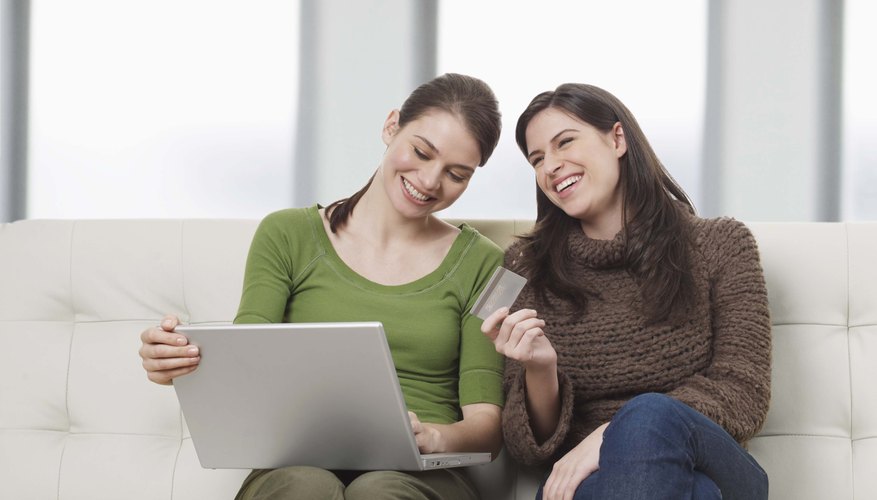 Women using credit card with laptop
