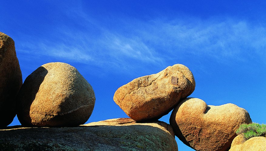 Granite boulders like these are shaped by spheroidal weathering. Granite boulders like these are shaped by spheroidal weathering.