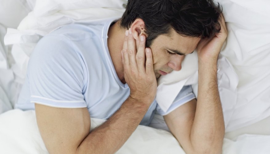 Man waking up due to pain Man waking up due to pain