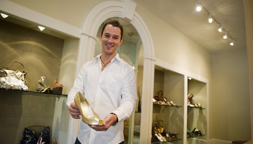 Photo Credit: Purestock/Purestock/Getty Images Man holding up shoe in shoe store.