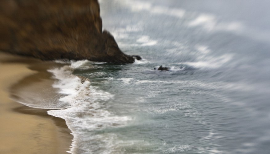 Photo Credit: Thinkstock/Stockbyte/Getty Images The moon's far away, but it still affects the Earth's waters.