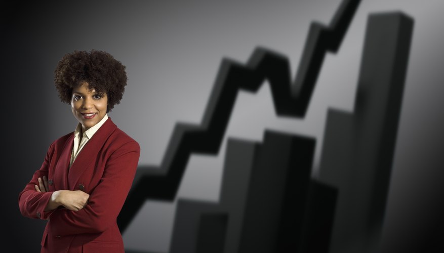 Studio portrait of businesswoman with graphs behind