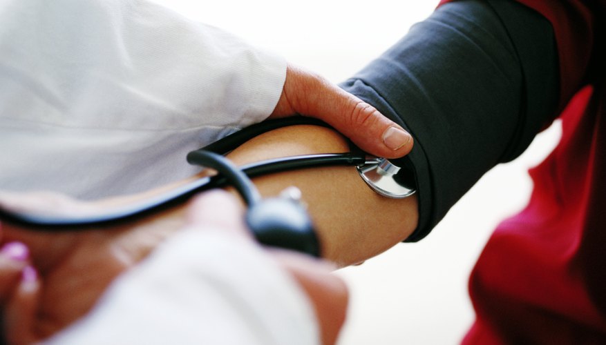 Doctor checking blood pressure Doctor checking blood pressure
