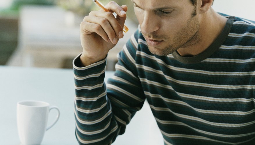 Serious Looking Man Examining a Bill