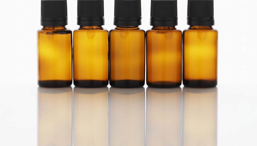 Five bottles of aromatherapy oil side by side