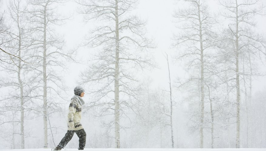 Photo Credit: Thomas Northcut/Photodisc/Getty Images Woman walking in snow.
