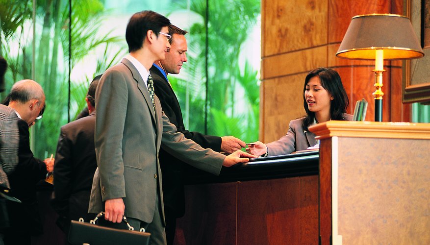 Two men checking into hotel