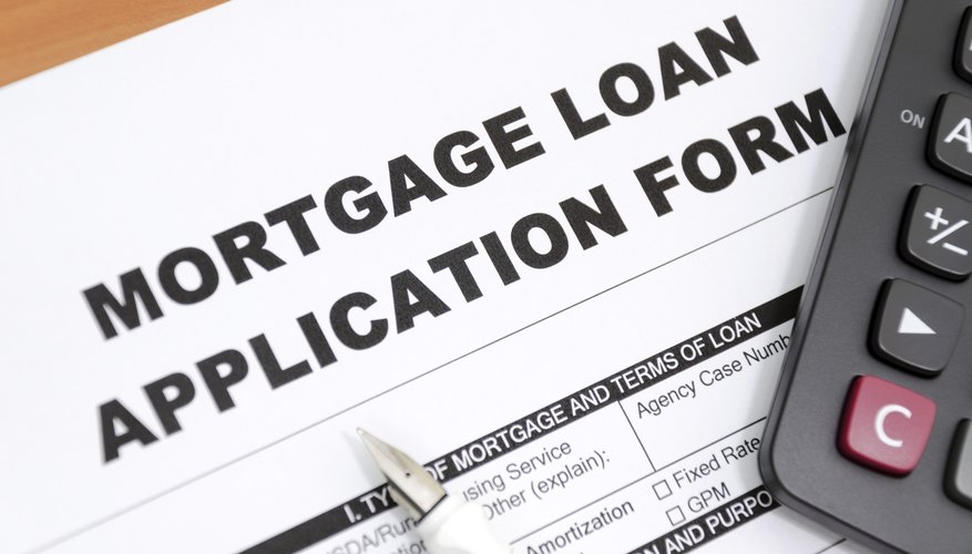 Mortgage loan form with pen and calculator.