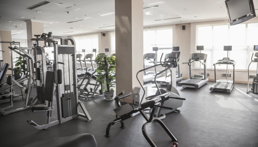 Large, bright gym with workout equipment.