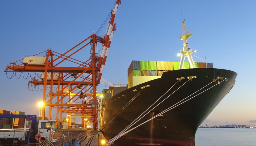 Container Cargo freight ship with working crane bridge in shipyard