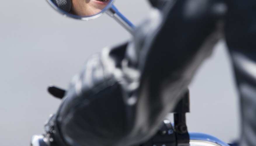 Reflection of motorcyclist in side mirror