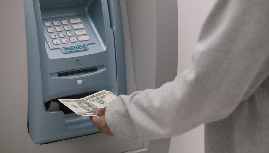 Man receiving money from an ATM.