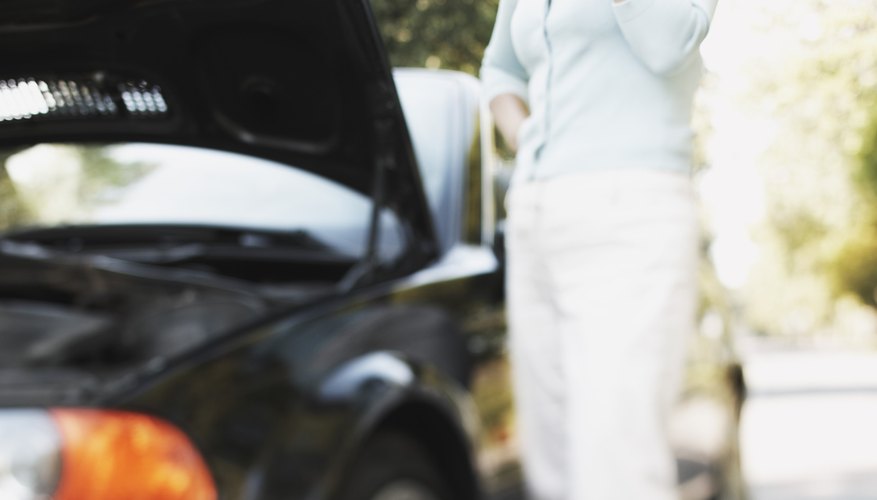 Woman with cell phone reporting car trouble