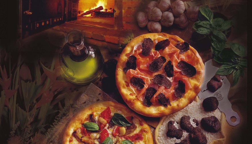Pizza's are common foods cooked in a brick oven Pizza's are common foods cooked in a brick oven