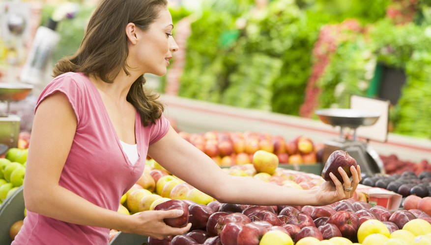Woman shopping for apples at a grocery store