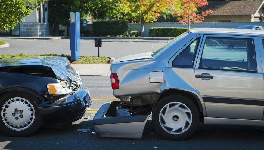 Car accident with a rear bumper on the ground.
