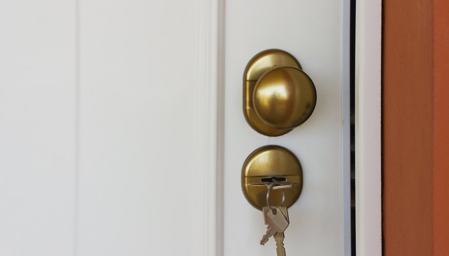 A close-up of keys in an apartment door.