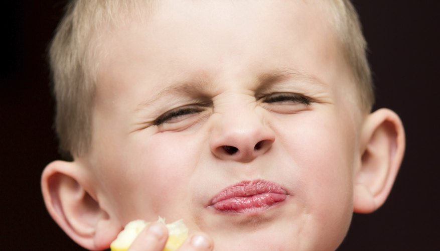 Photo Credit: pohreen/iStock/Getty Images Boy making a funny face after eating a lemon.