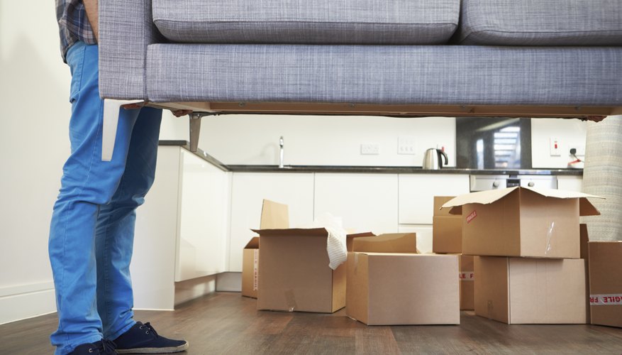 Photo Credit: monkeybusinessimages/iStock/Getty Images Man lifting couch