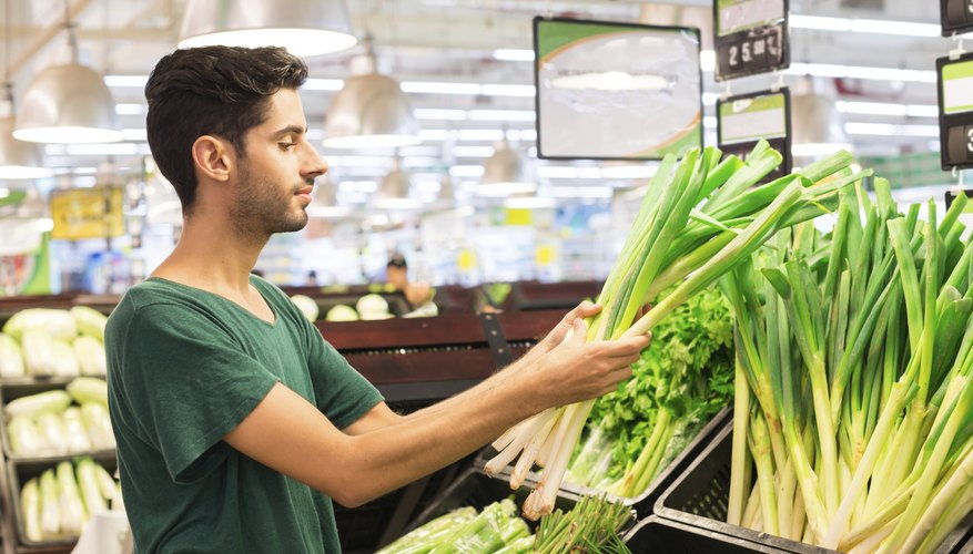 A man is buying produce from the grocery store.
