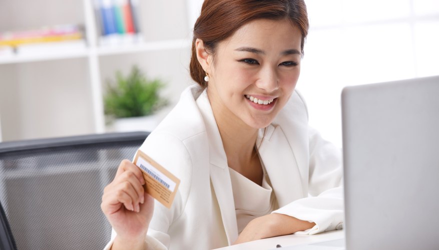 Woman using credit card to make an online purchase.