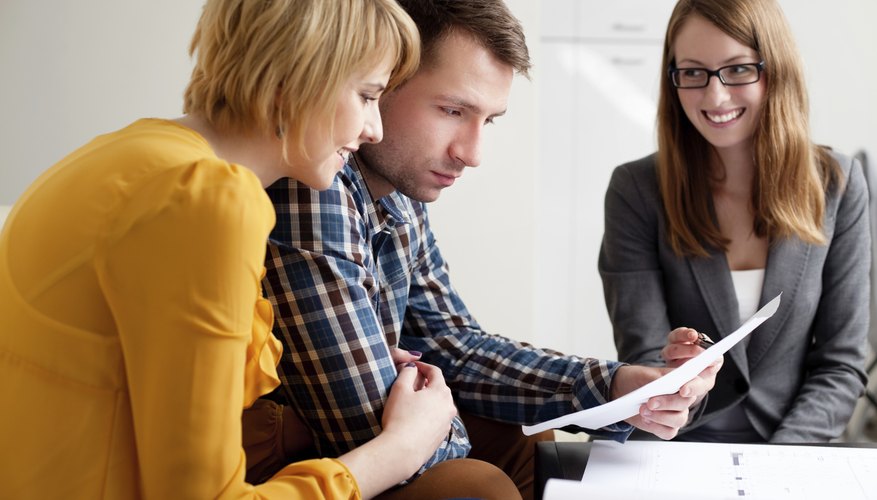 Young couple looking at mortgage statement.