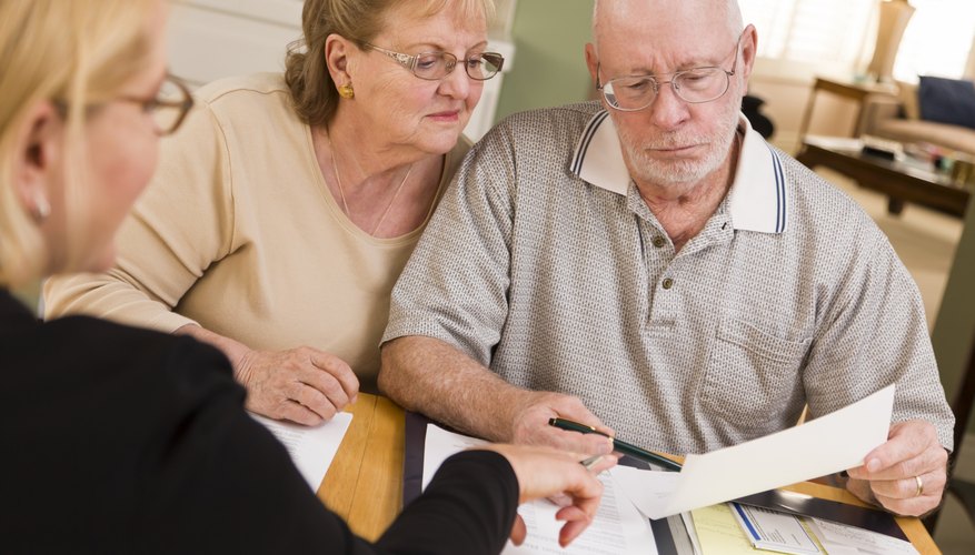 A man and woman are filling out paperwork together.