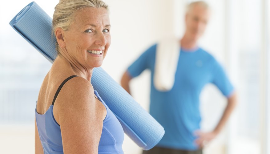 Photo Credit: tetmc/iStock/Getty Images Older couple with yoga mats