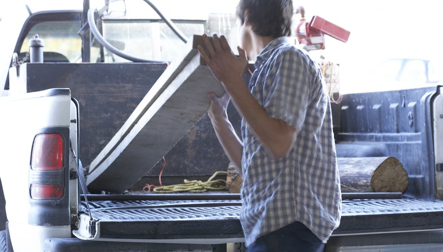 Man unloading boards from truck