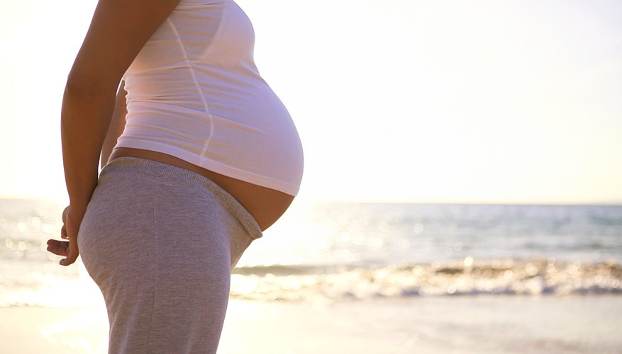 A pregnant woman at the beach A pregnant woman at the beach