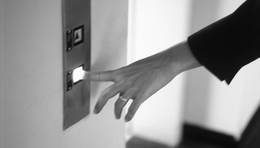 Woman's hand pushing elevator button