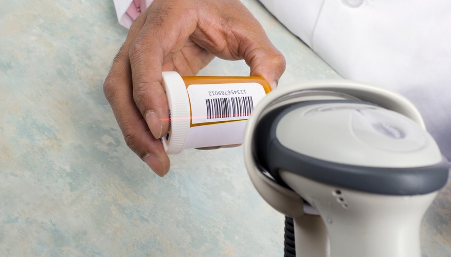 Pharmacist scanning pill bottle with a barcode