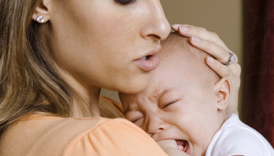 Mom comforting crying baby Mom comforting crying baby