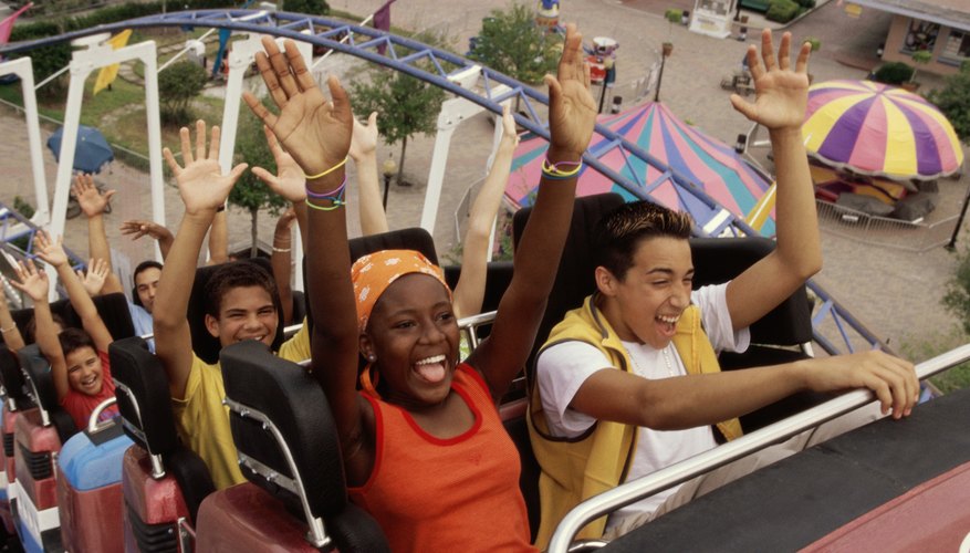 Teenage boys and girls on a roller coaster ride