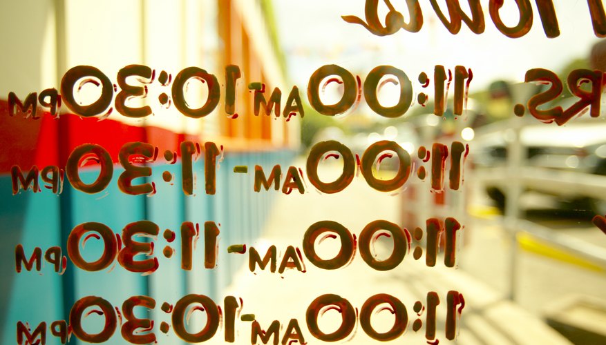 Open hours on window of small business