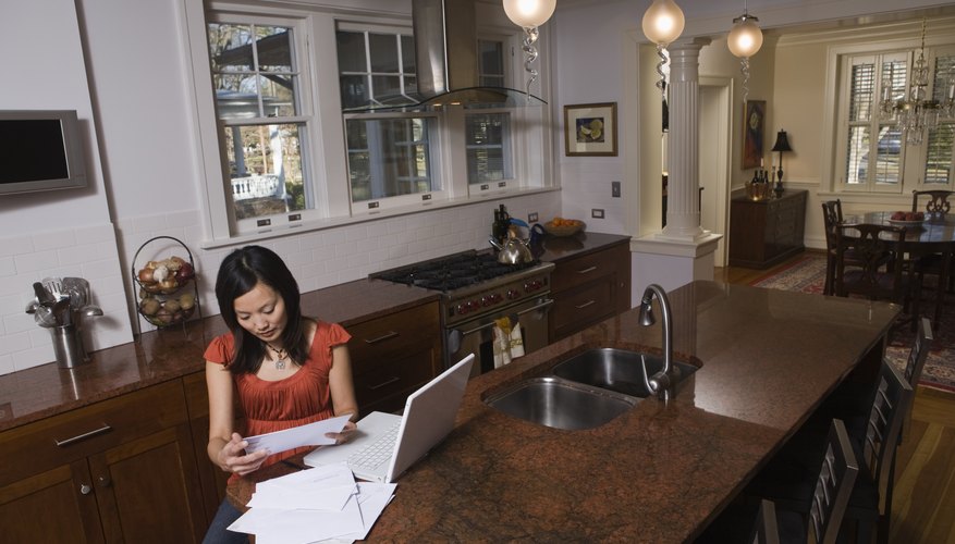 Woman working on tax paperwork in her home.