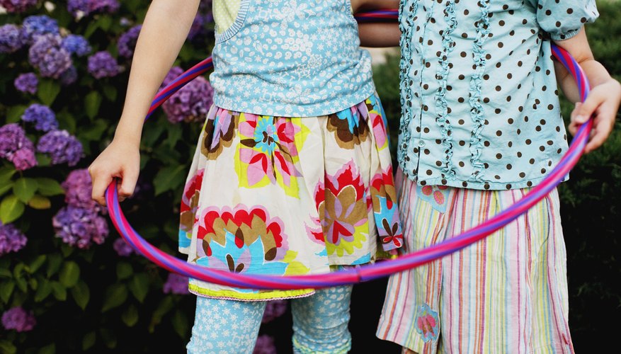 Photo Credit: Jupiterimages/Photos.com/Getty Images Children standing together in hula hoop