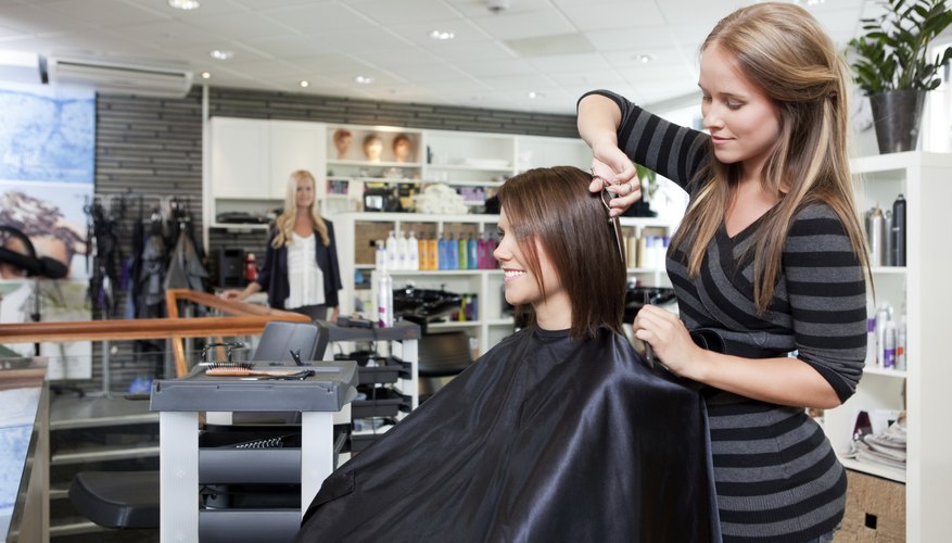 Photo Credit: tyler olson/iStock/Getty Images hairdresser styling woman's hair