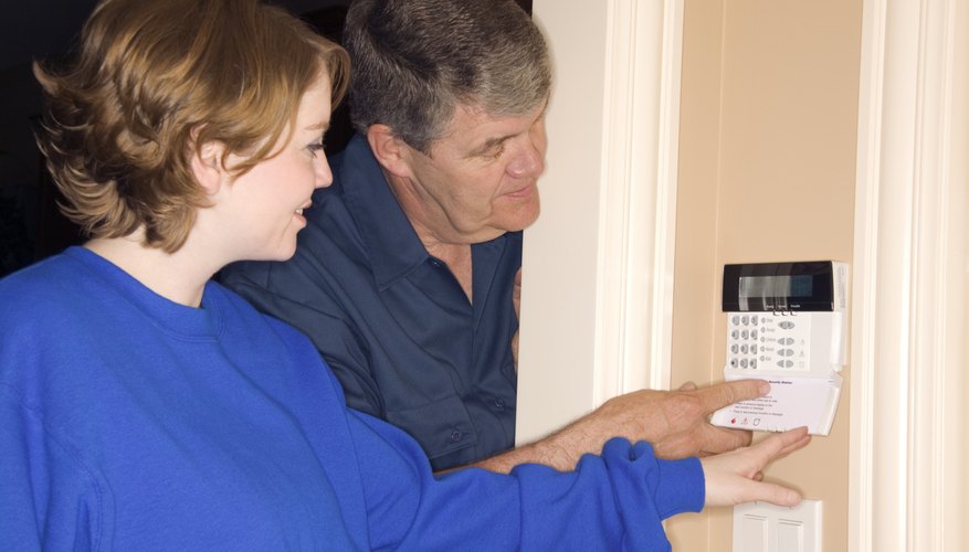 Man and woman setting home alarm system